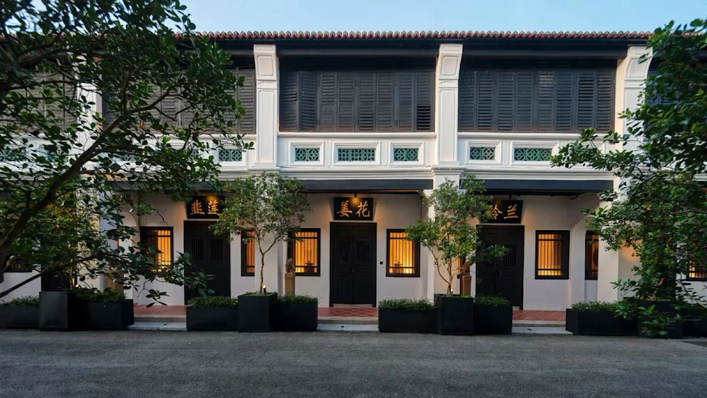The restored heritage shophouse terrace in the Khoo Kongsi compound, George Town, at dusk.