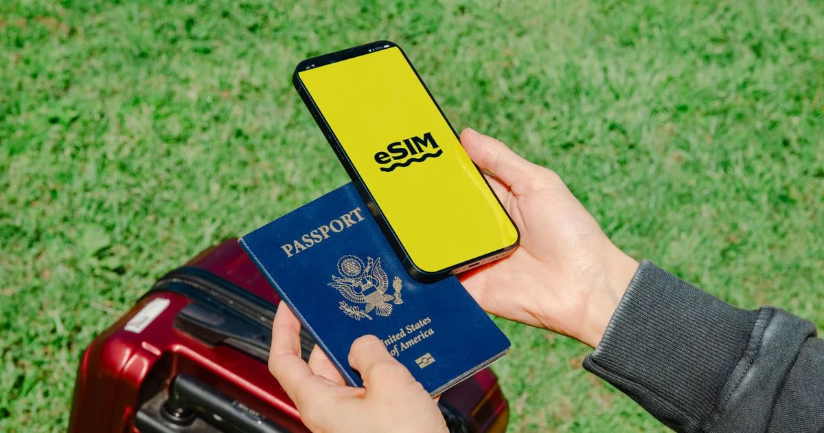 A traveller's hands holding a smartphone and an open passport beside luggage.  (source: https://images.pexels.com/photos/20805602/pexels-photo-20805602.jpeg)