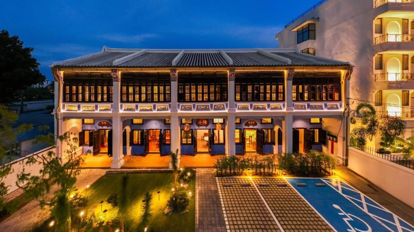 The indigo-blue 1904 annexe of the Cheong Fatt Tze Mansion in George Town, lit at dusk.