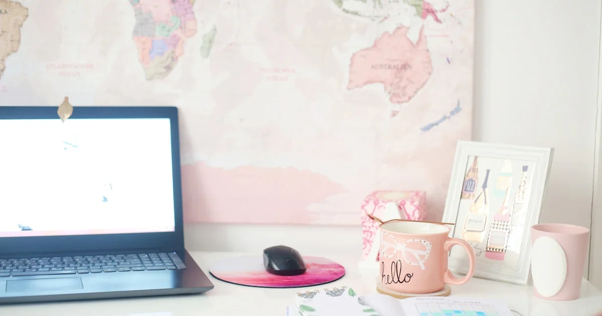 A tidy desk with an open laptop and coffee, ready for drafting a policy.