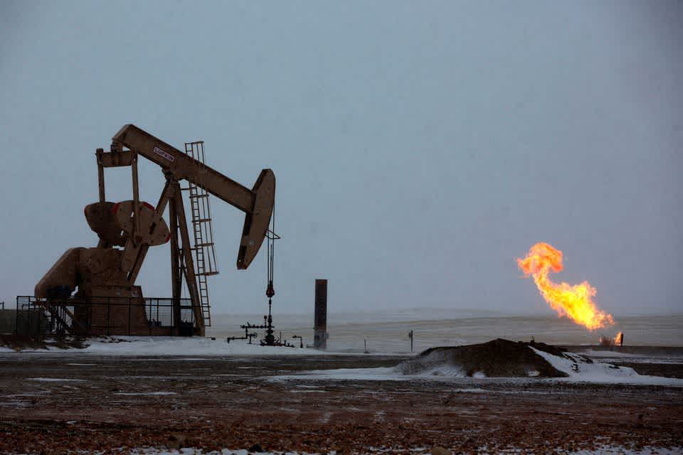 Natural gas flares are seen at an oil pump site outside of Williston, North Dakota