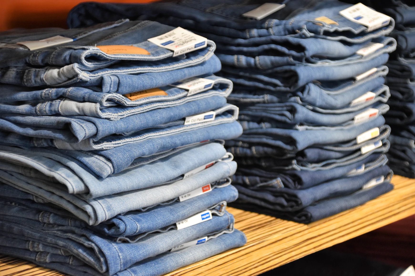 Image of folded denim on retail store shelf