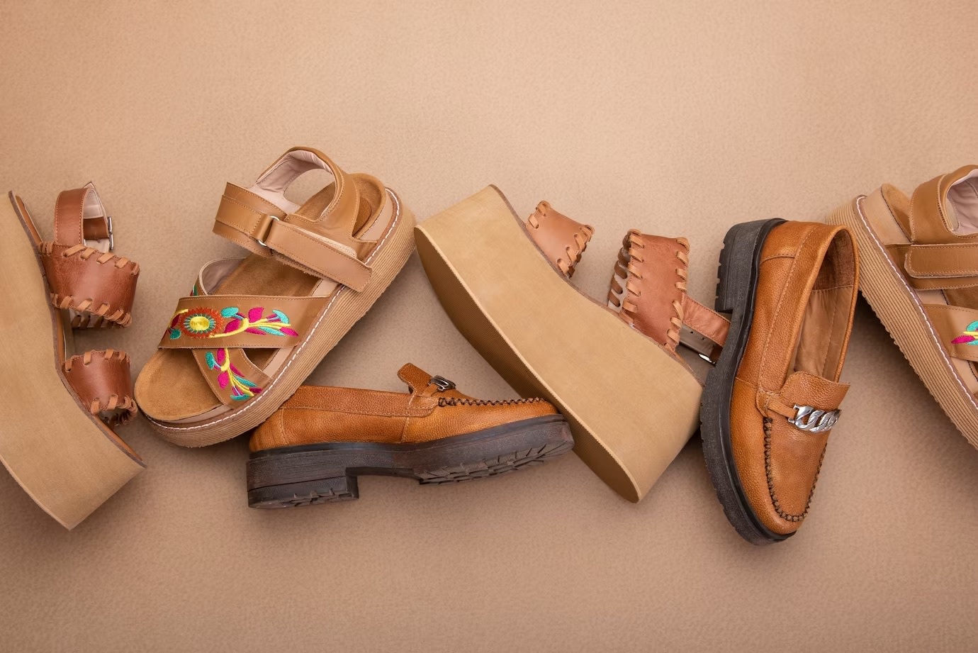 Image of different brown natural shoes on brown background