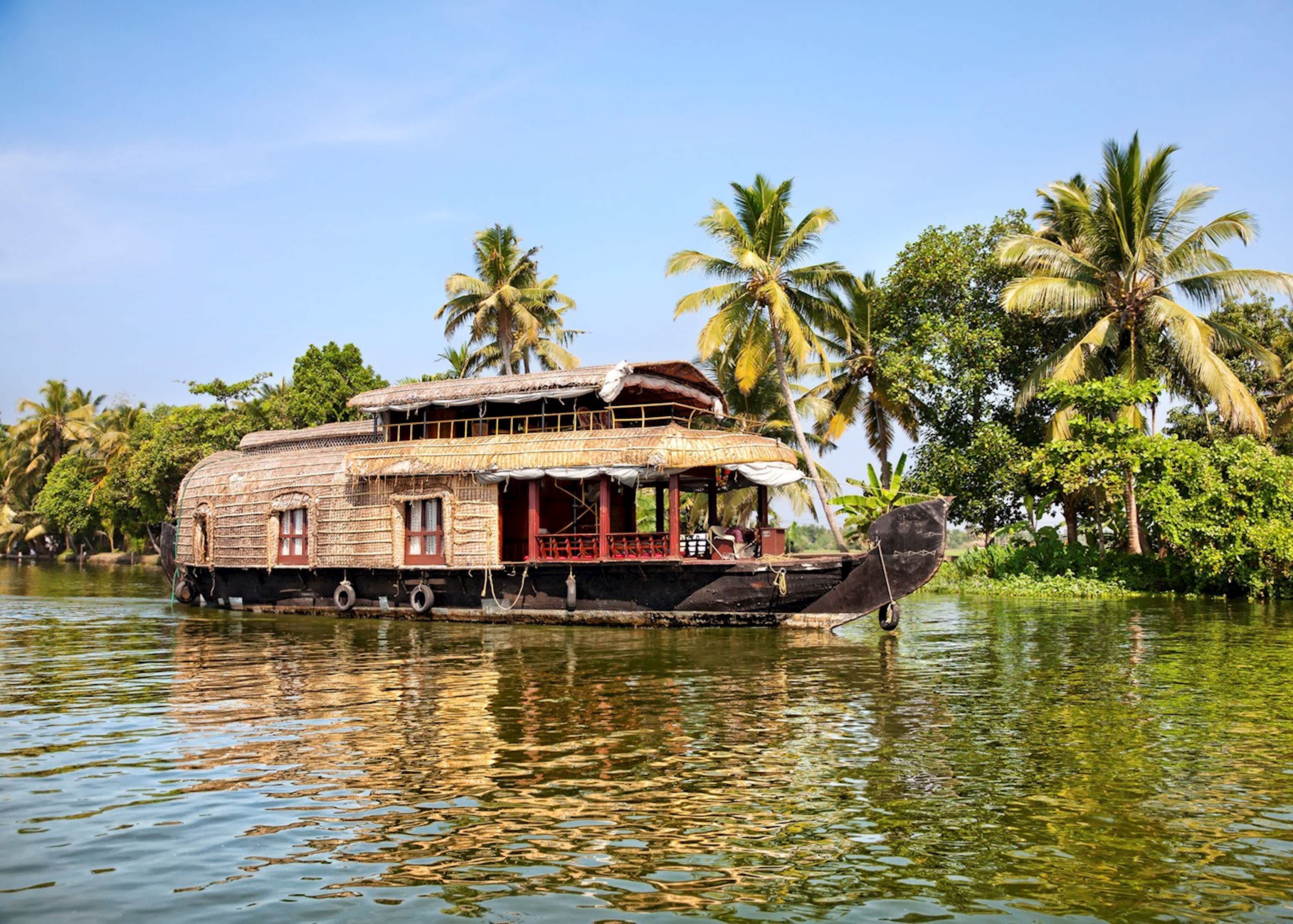 A houseboat cruises on the Vembanad Lake in Kerala, India.