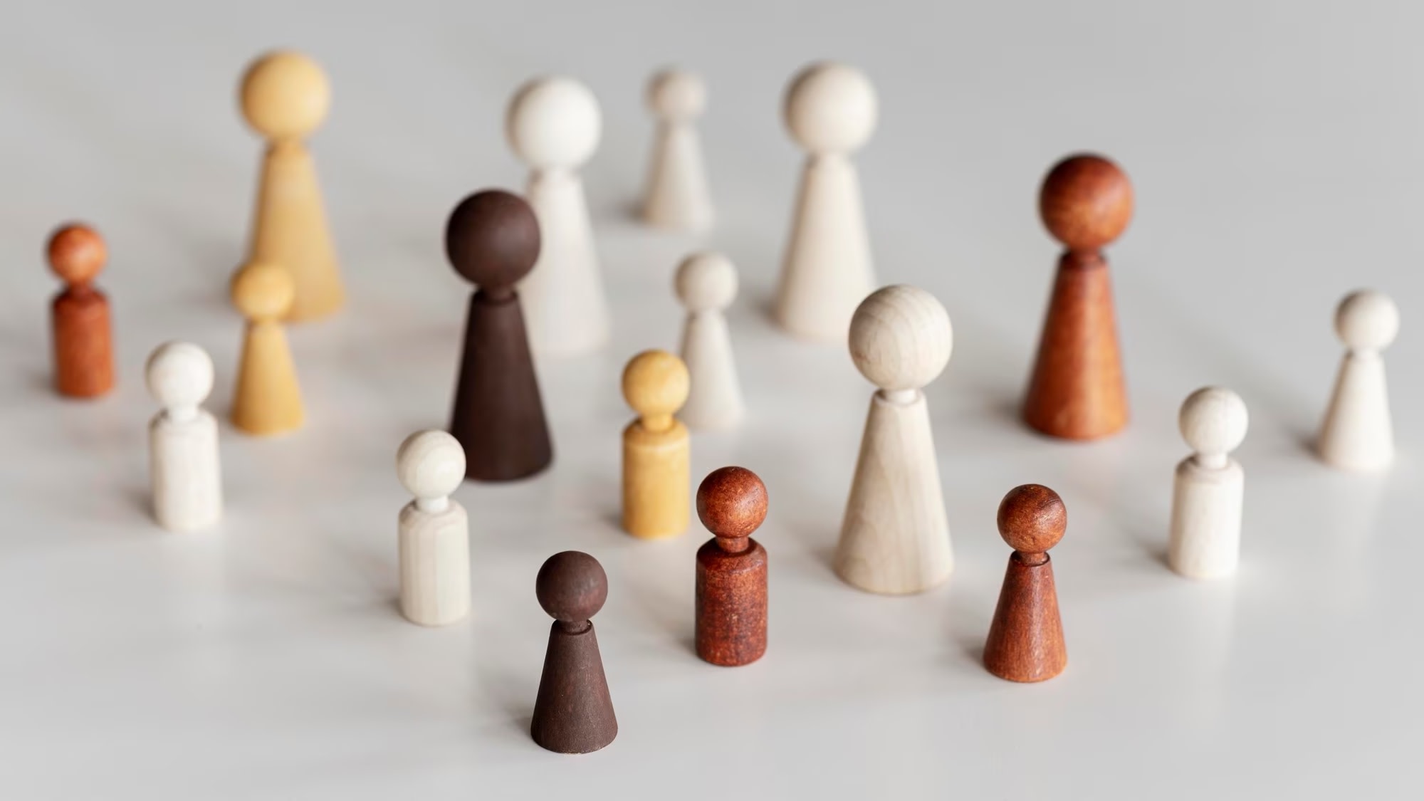 Image of diverse wooden game pieces representing human diversity
