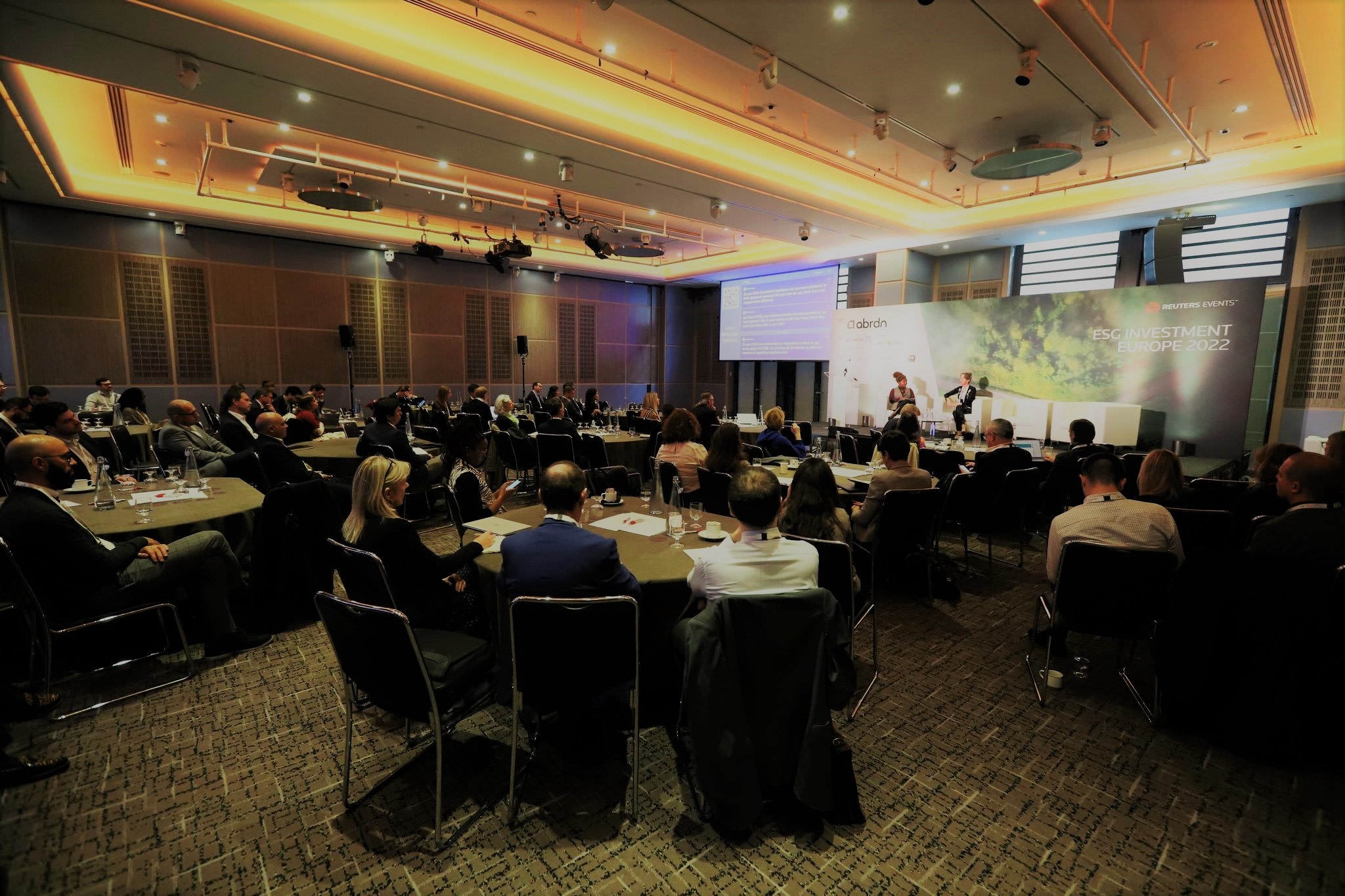 Image of Reuters ESG Investment Europe event, attendees seated listening to keynote speaker