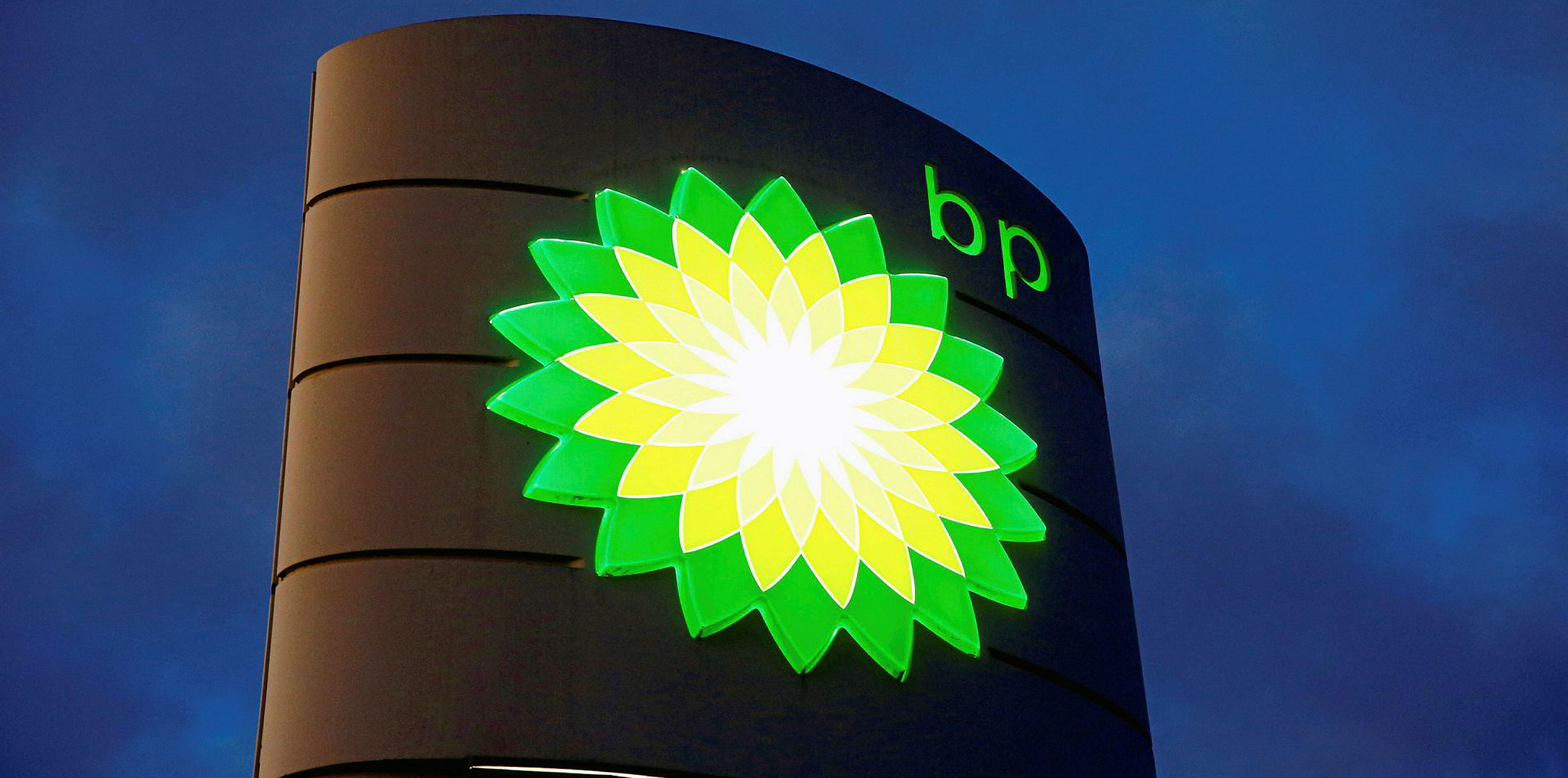 Image of BP logo on building, against background of dark sky