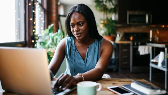 woman-at-home-researching-used-cars-online-iStock-1135393158