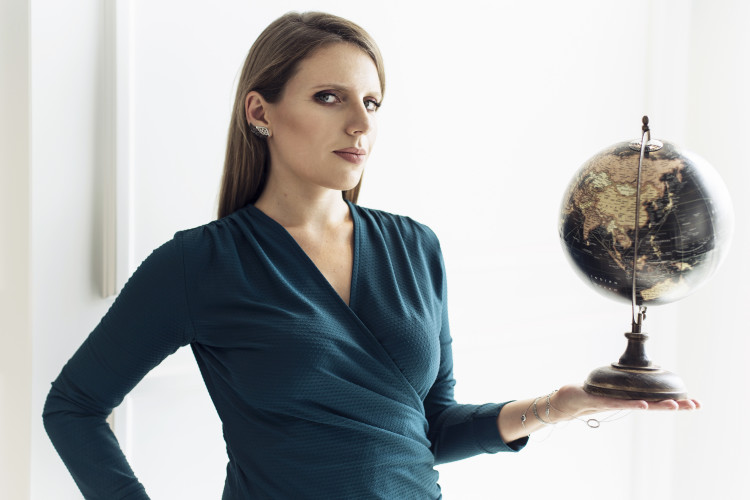 Image of Noemi Malska, GM for Europe at Findings, holding a globe of the Earth