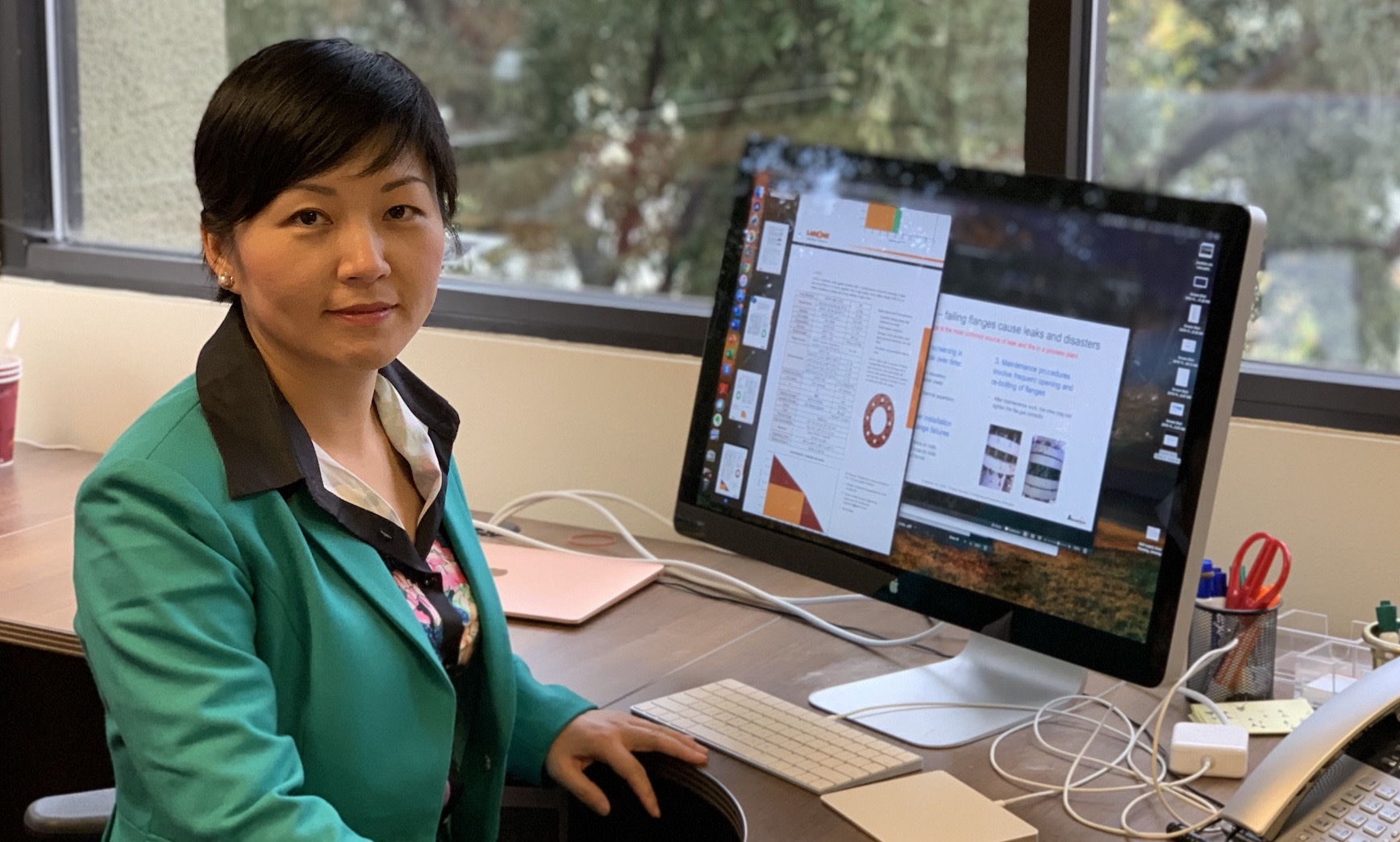Image of Jane Ren, CEO at Atomiton, sitting at desk with computer