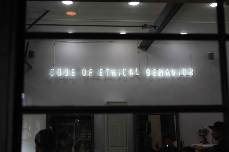 Image of neon lettered sign showing ''Code of Ethical Behavior"