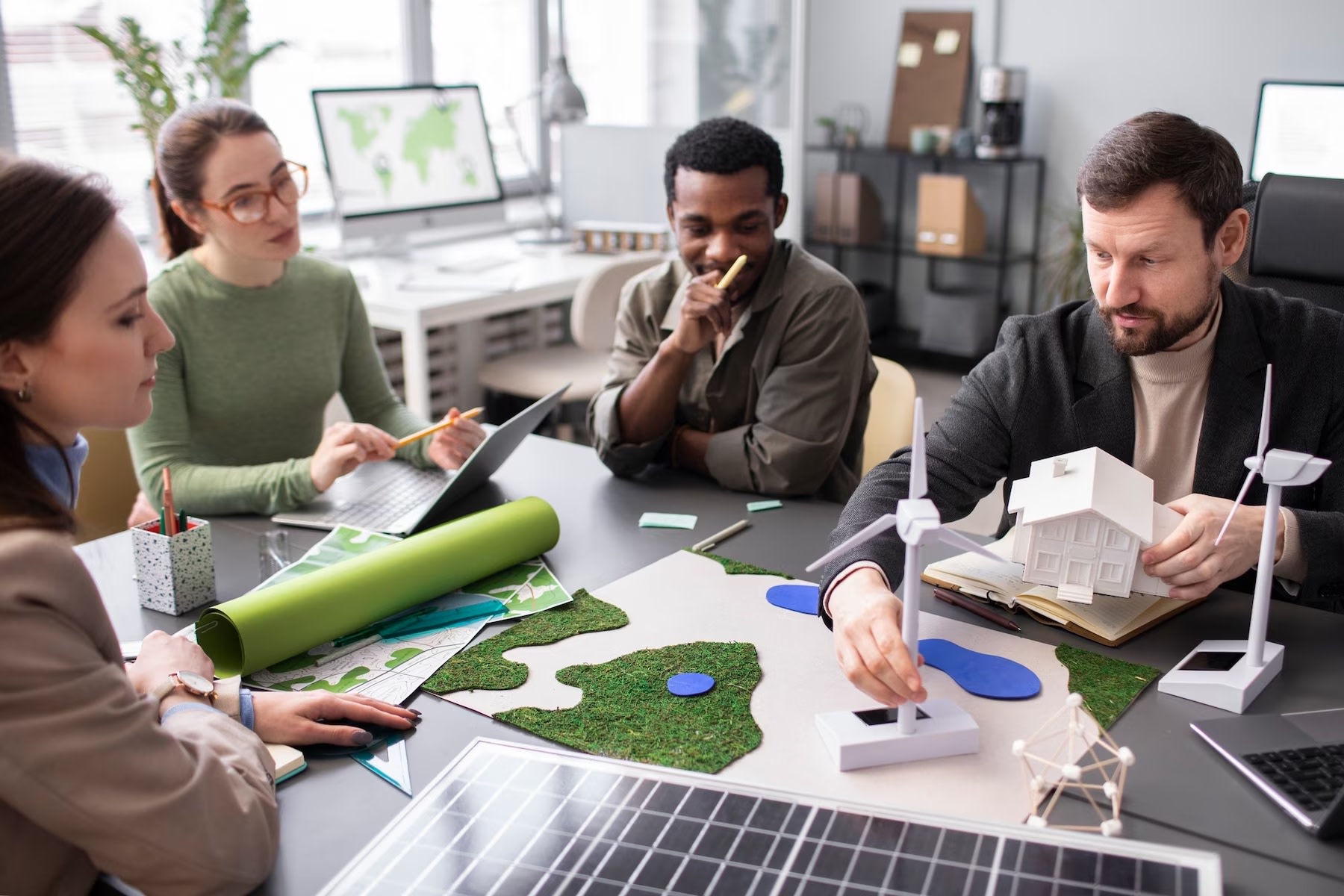 Group of workplace colleagues looking at sustainable energy resources