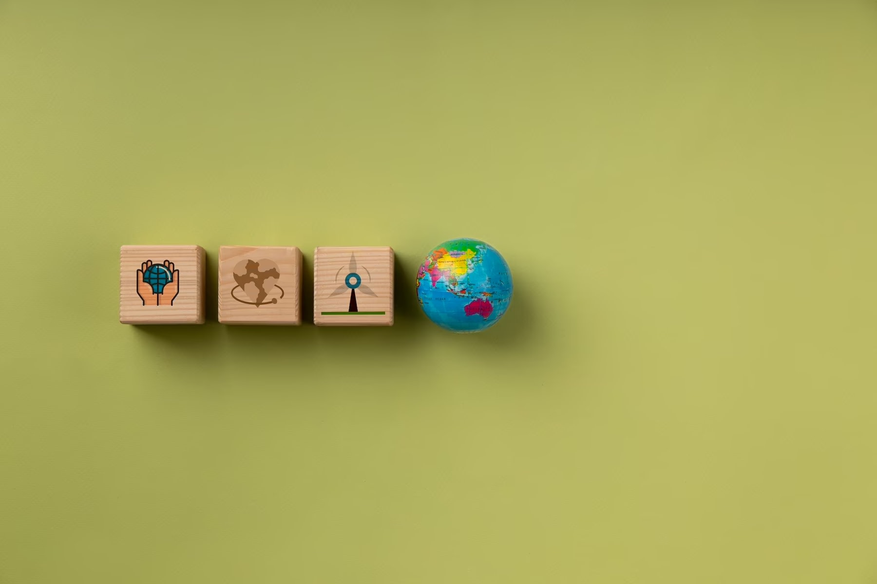 Image of SDG wooden blocks that lead to a globe of Earth