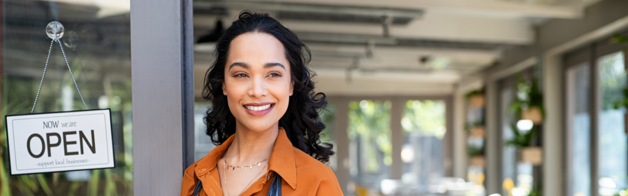 Small business owner at shop entrance