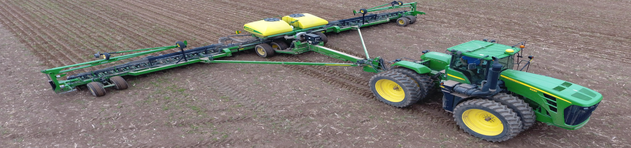 Using a John Deere tractor and planter to plant corn