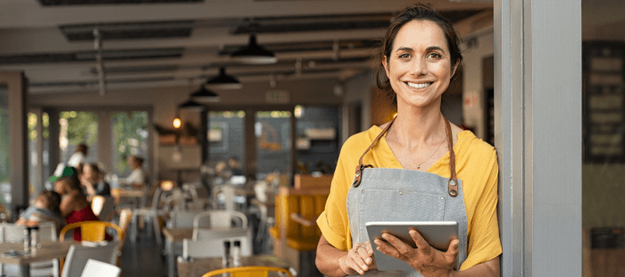 Woman smiling holding an iPad