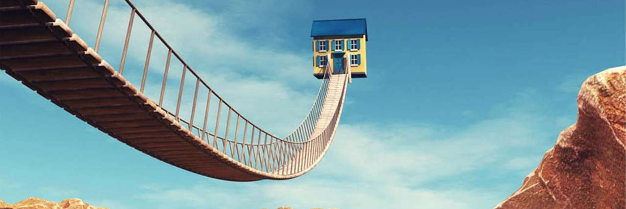 House with a bridge to represent how a UK SME can use bridging loans to finance a property purchase 