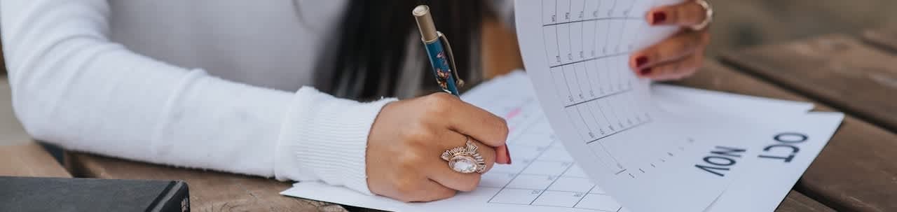 woman writing in calendar