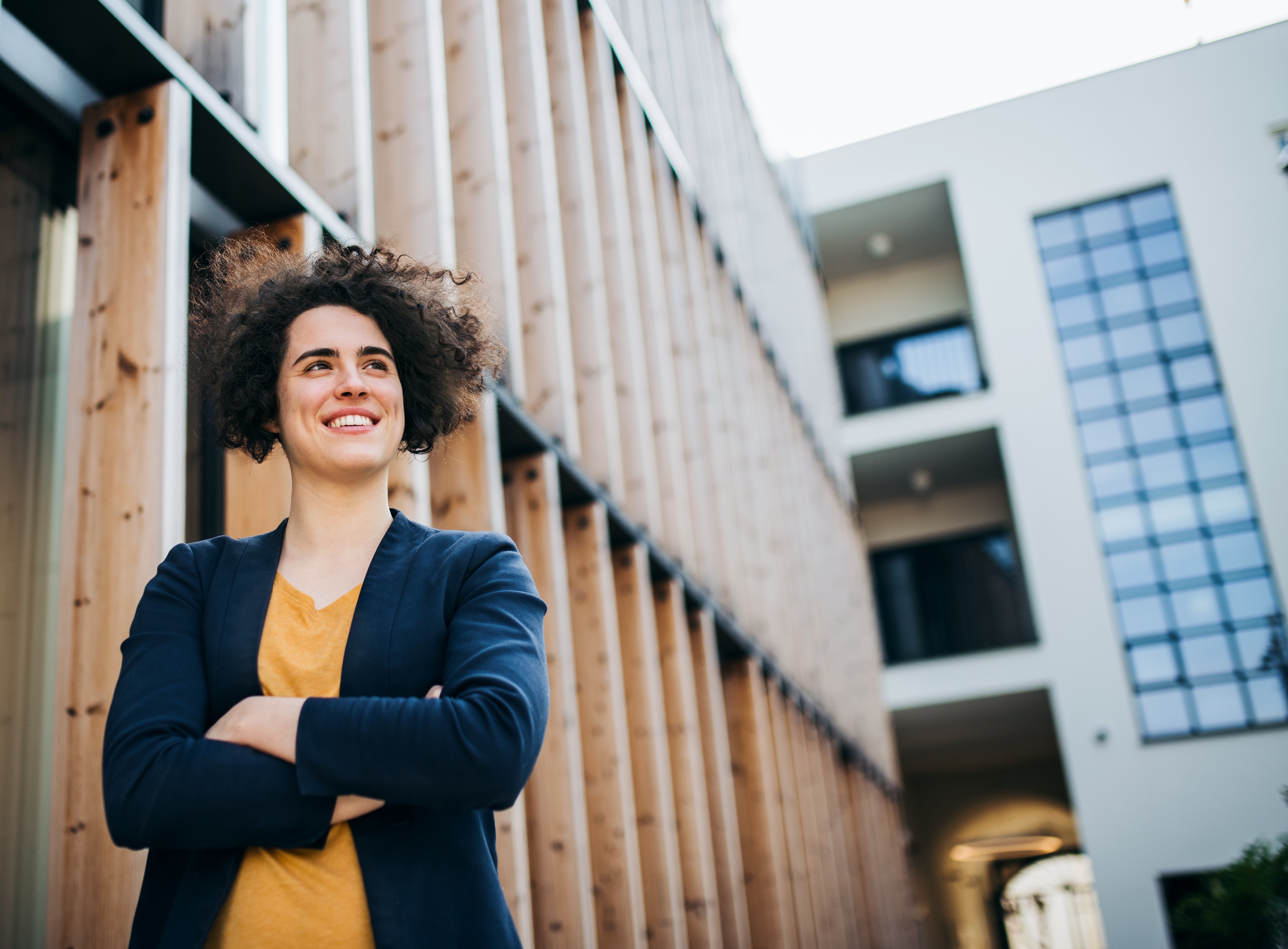 a-happy-young-business-woman-standing-outdoors-re-2022-02-02-04-50-31-utc