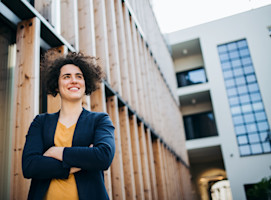a-happy-young-business-woman-standing-outdoors-re-2022-02-02-04-50-31-utc