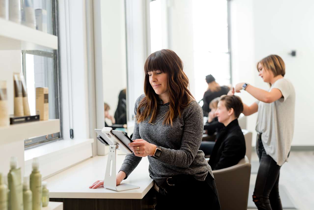 Woman looking at tablet in a salon