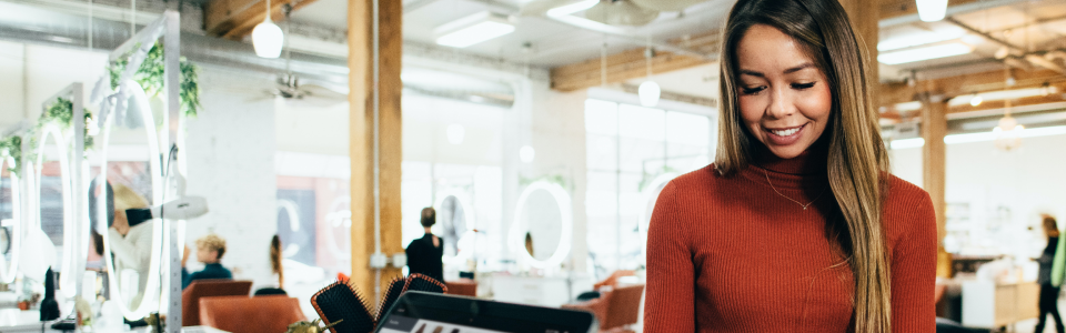 Woman making payment at credit card terminal