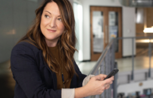 woman looking away whilst typing on phone