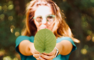 woman holding a leaf