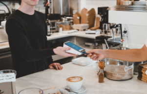 a man take a card payment on card machine