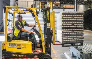 man driving forklift truck in warehouse