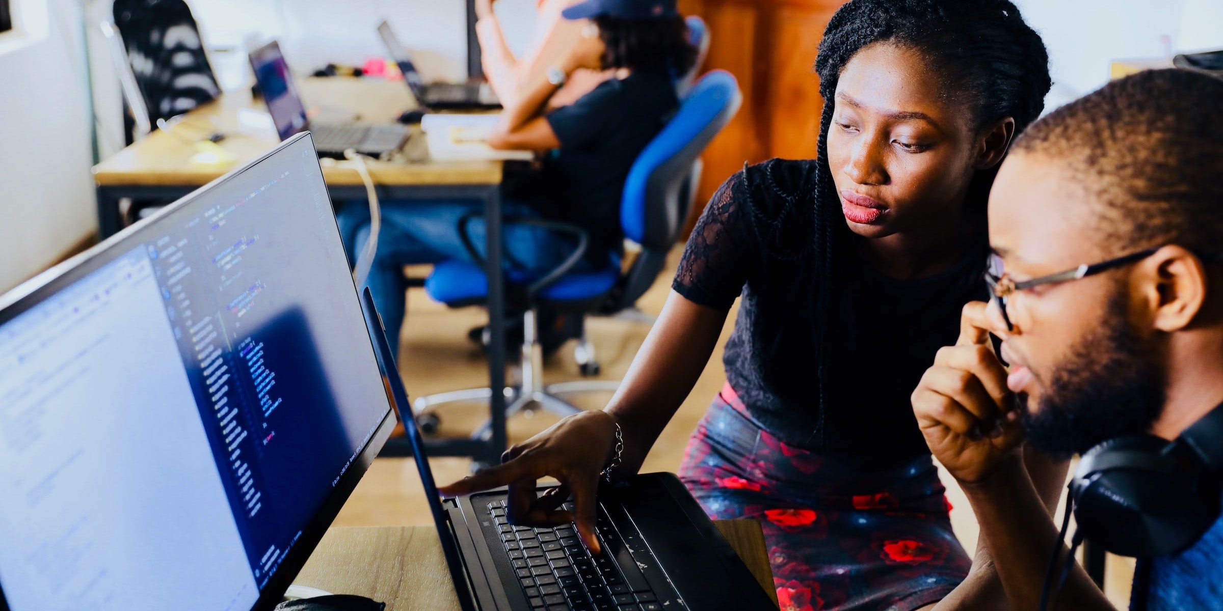 Man and woman looking at code