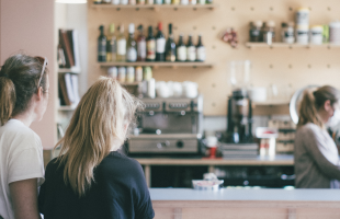 women queuing to order coffees at coffee shop