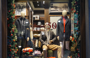 Menswear shop window display with discounts