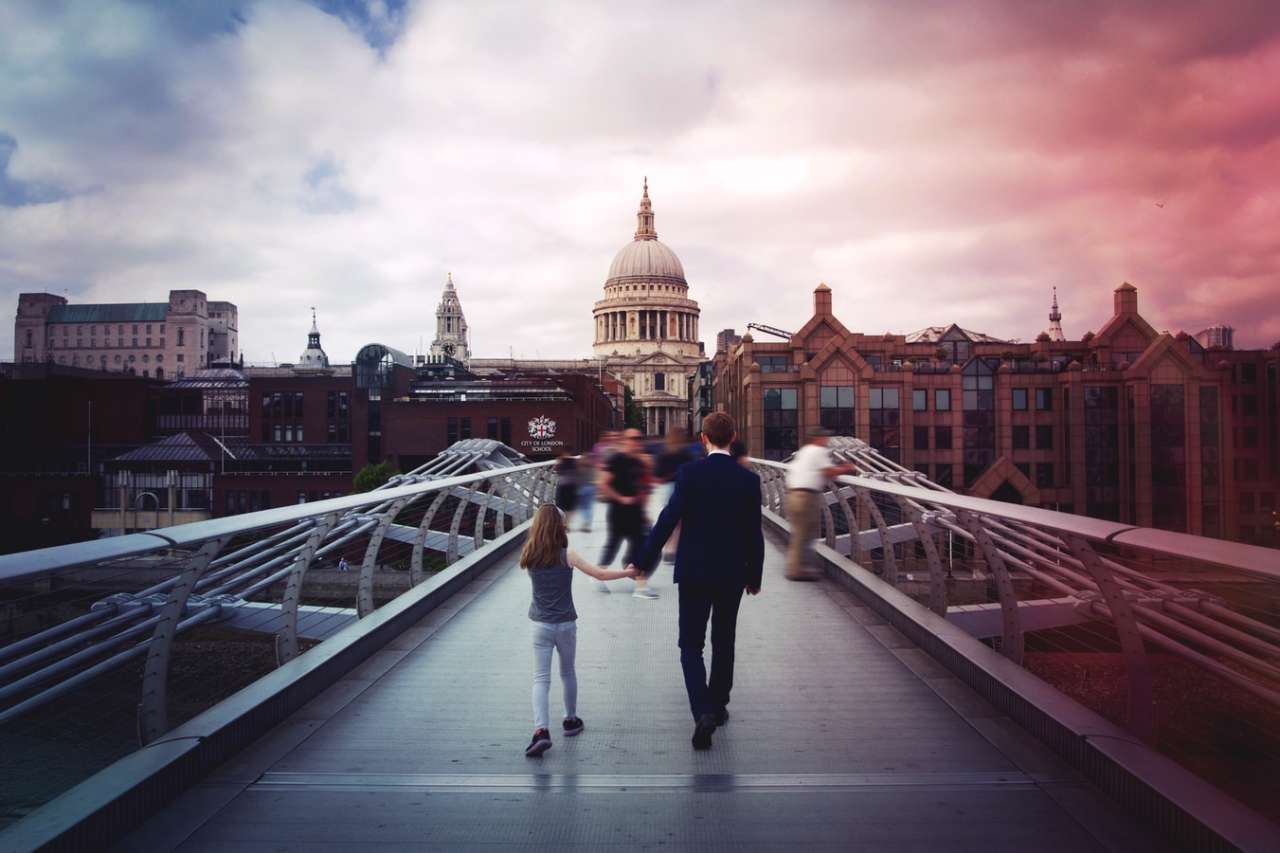 Man and girl walking over bride towards St Pauls Cathedral