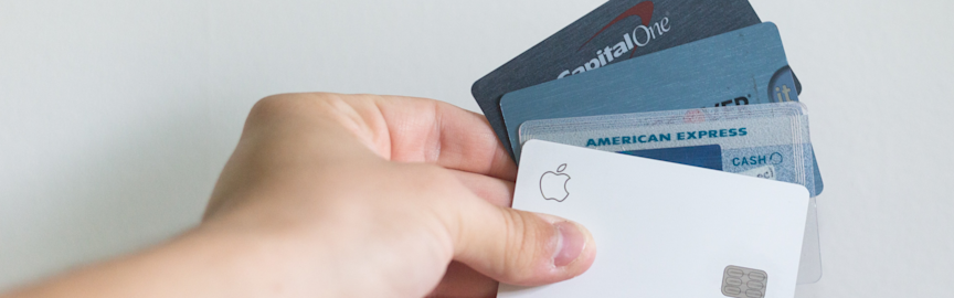 man holding a selection of credit cards