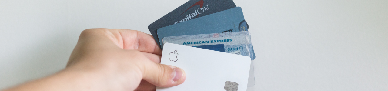 man holding a selection of credit cards