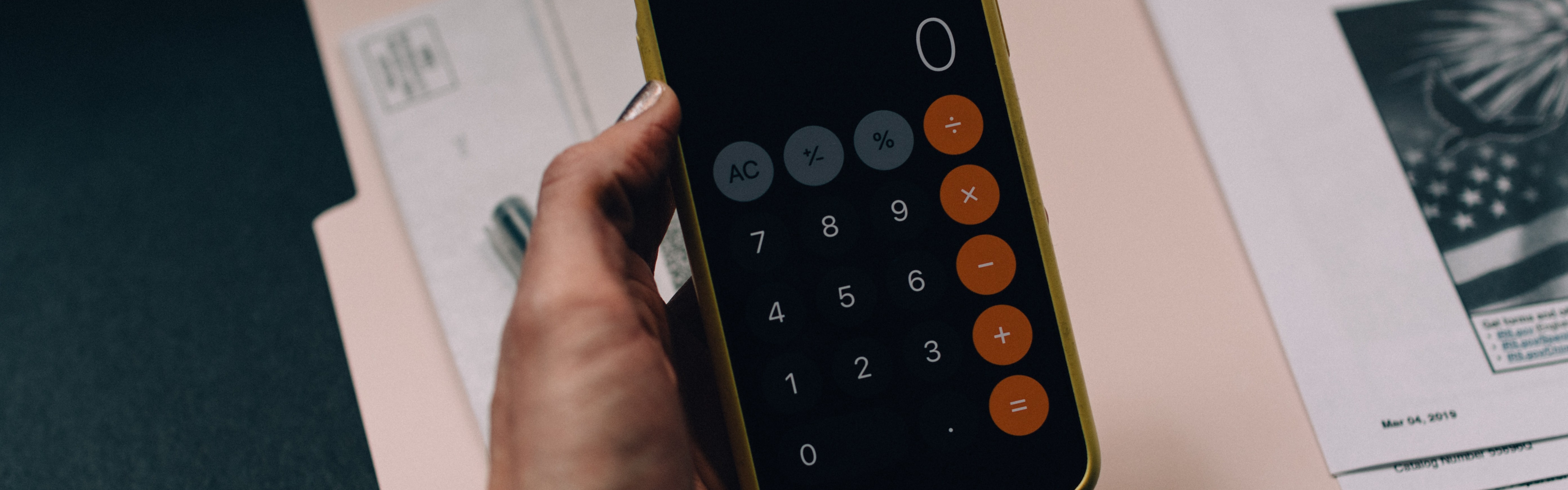 Holding phone showing calculator