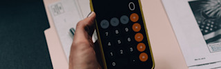 Holding phone showing calculator