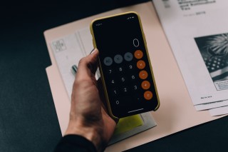 Holding phone showing calculator