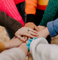 Hands grouped together to represent business crowdfunding investment