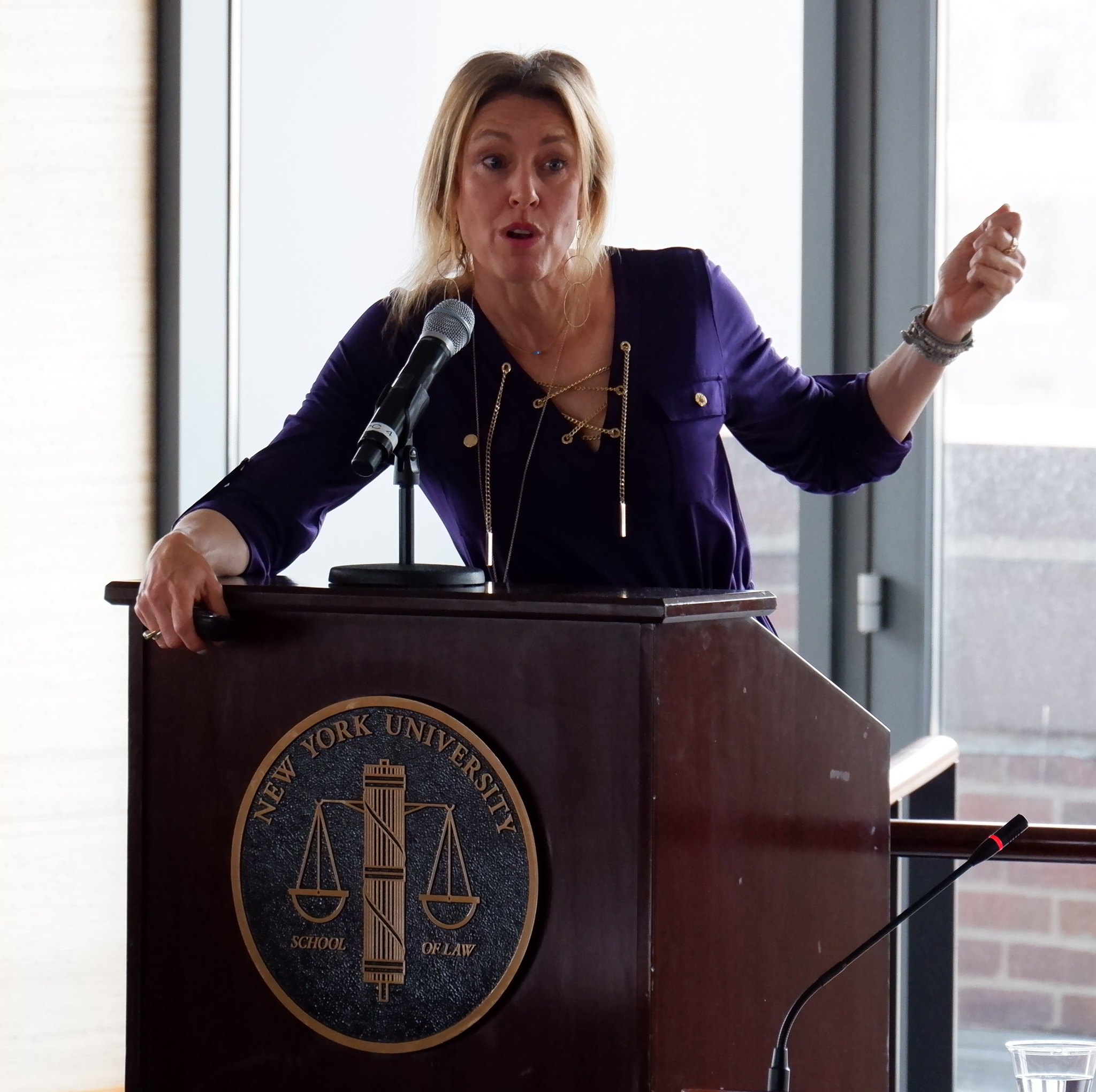 Professor Orly Lobel behind the podium with an NYU seal