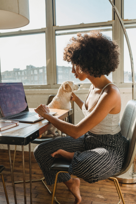 Woman working from home sitting with dog