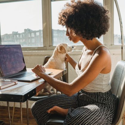 Woman working from home sitting with dog