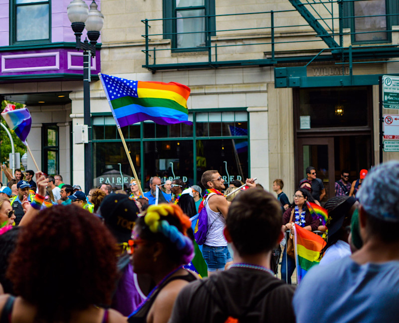 Canva people gathered near building holding flag at daytime