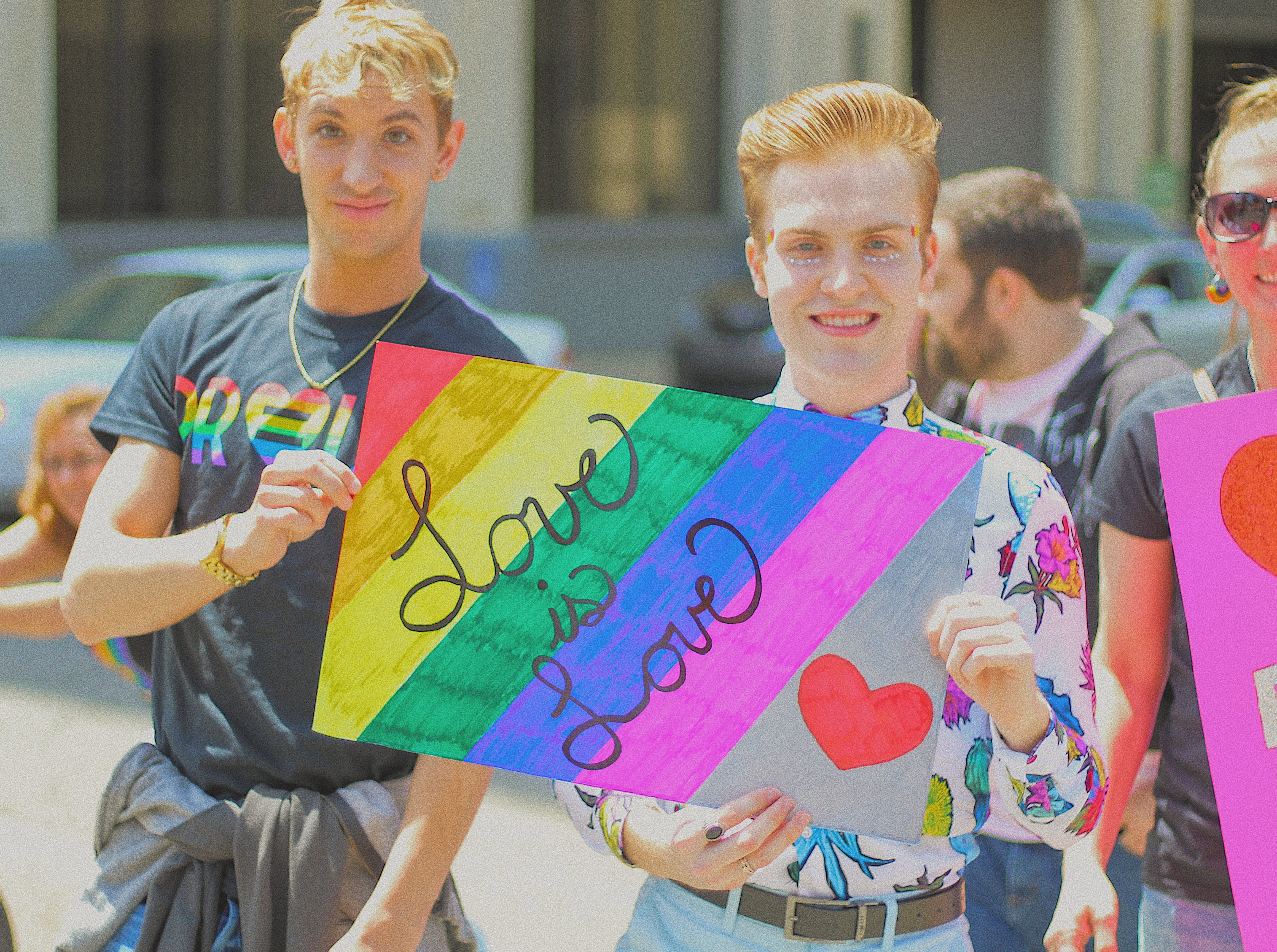 Two men holding sign that reads, 