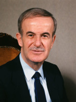 Government of Syria, Public domain, via Wikimedia Commons Hafez al-Assad