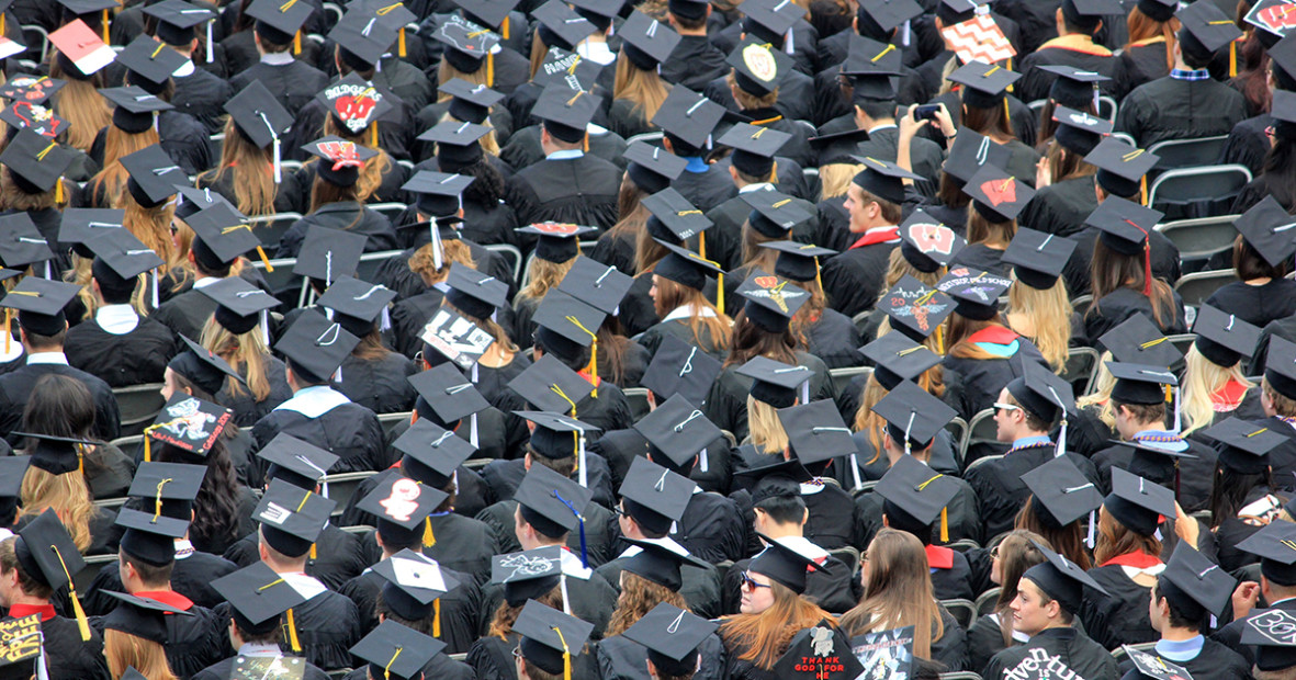 A crowd of students wearing graduation caps and gowns. 