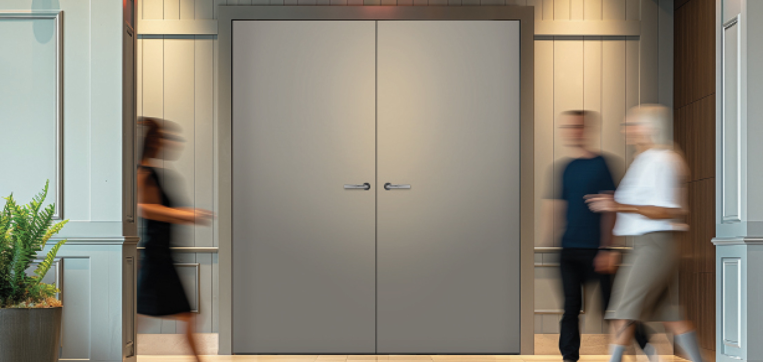 People walking by a gray Forte Openings door