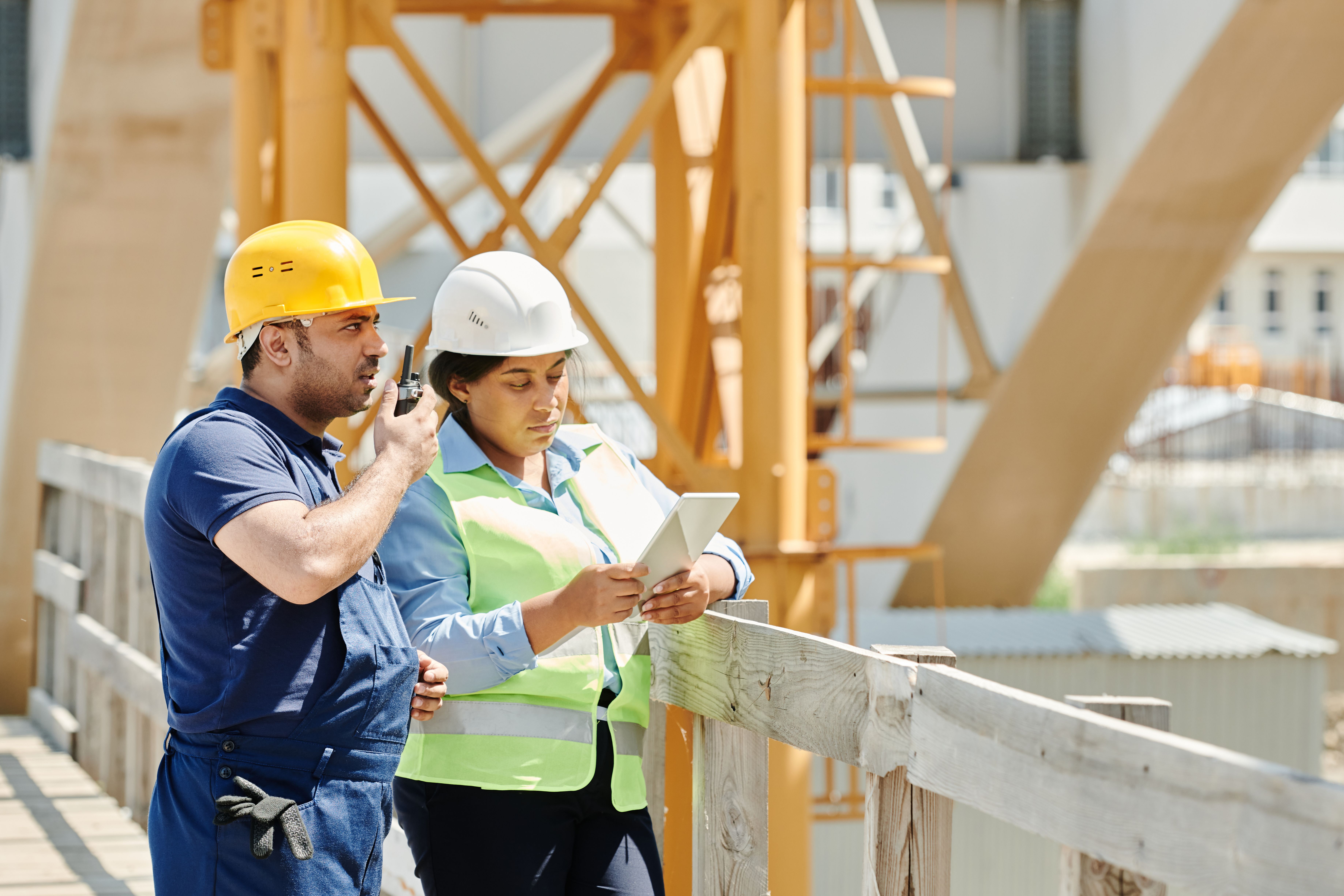 Site worker checking the crew schedule on a tablet