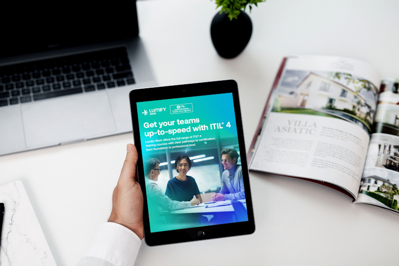 LFY - Work - eBook - ITIL - 2024 2.6 mockup-of-a-man-holding-an-ipad-mini-over-his-work-desk-2112-el